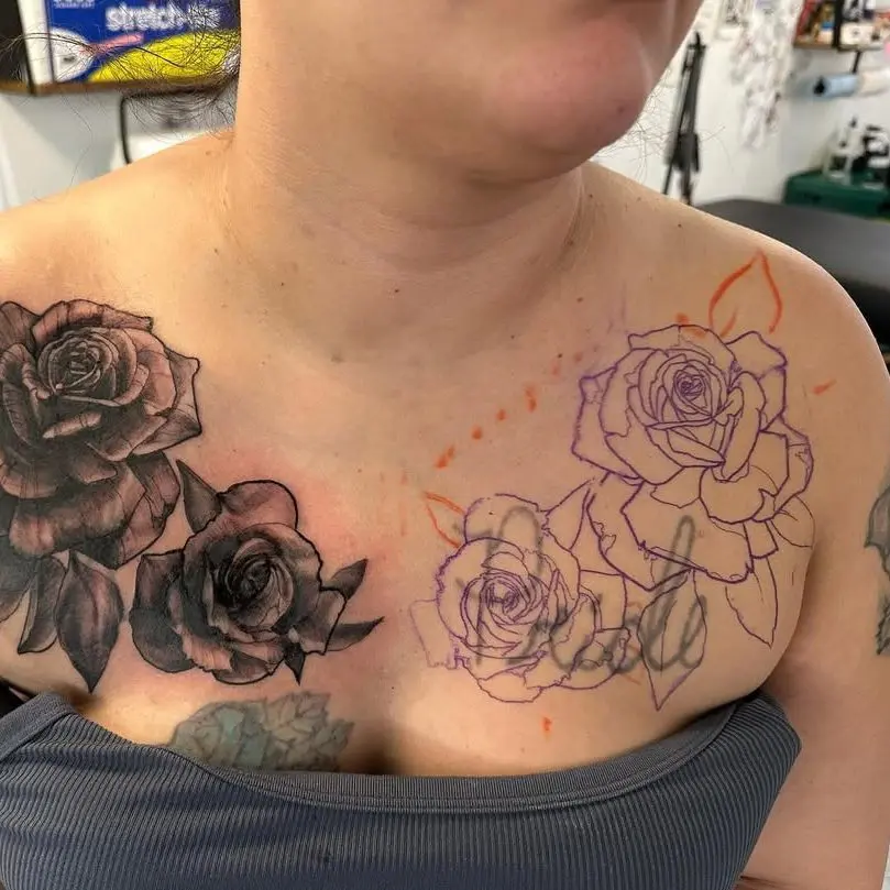 stencil placement of a cover up tattoo . Roses are covering a poorly done lettering tattoo saying "pride"
