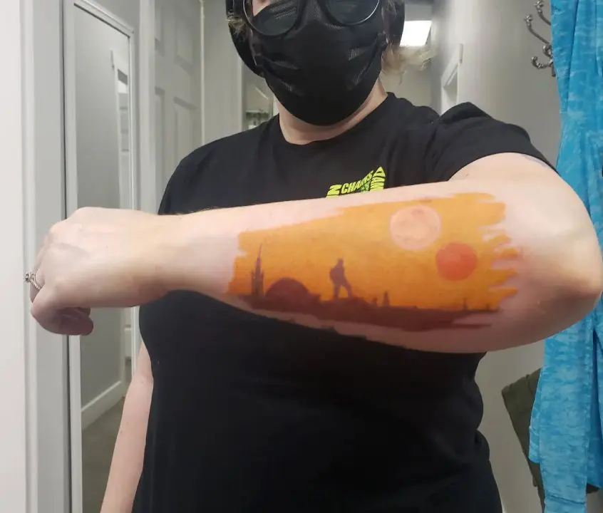 Colorful forearm tattoo of a scene from Star Wars episode 4