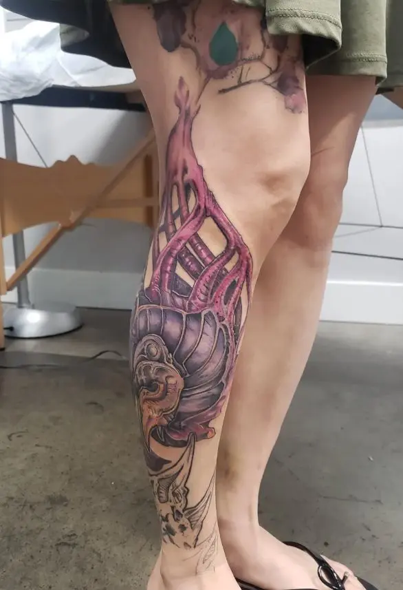 biomech and water color tattoo on outside of calve