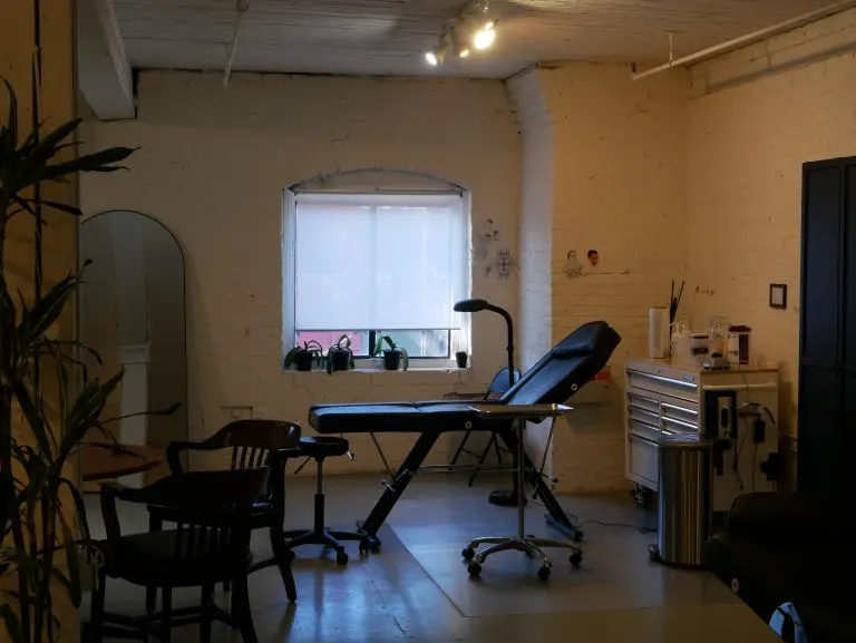 A tattoo station under the arched window
