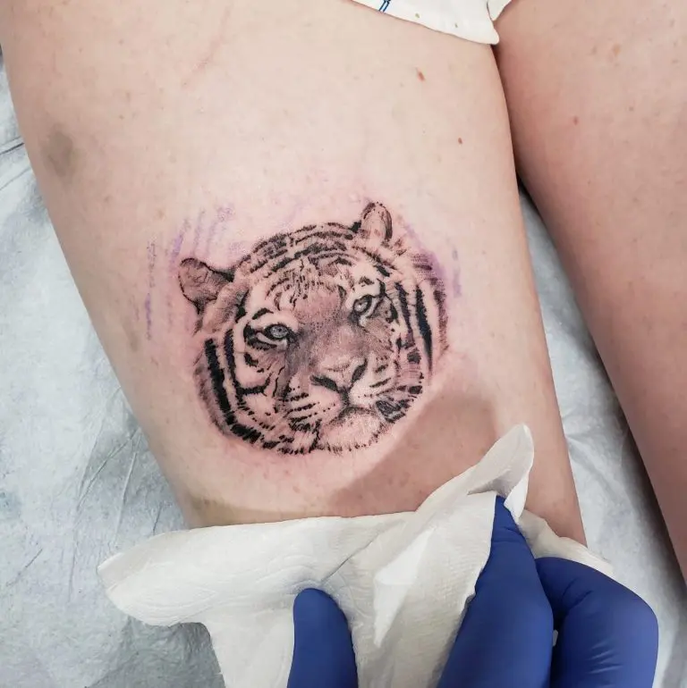 Ultra fine line realism tiger head on a thigh, about 2 inches square