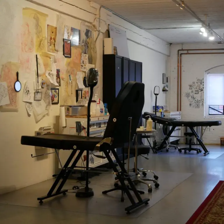 Mesa Tattoo studio floor with tattoo stations and art on the walls