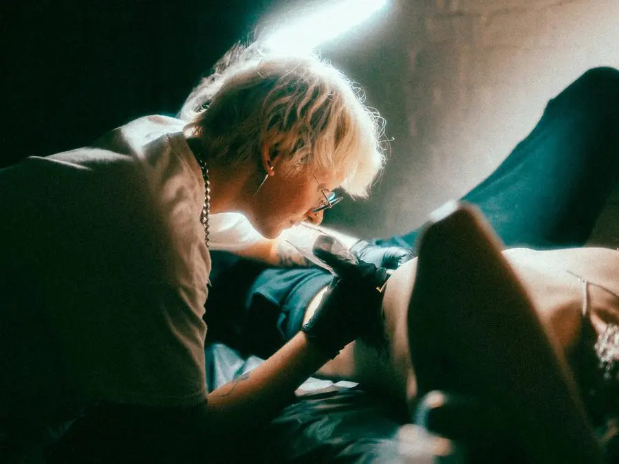 Birdy Everhart tattooing a large-scale piece in the studio